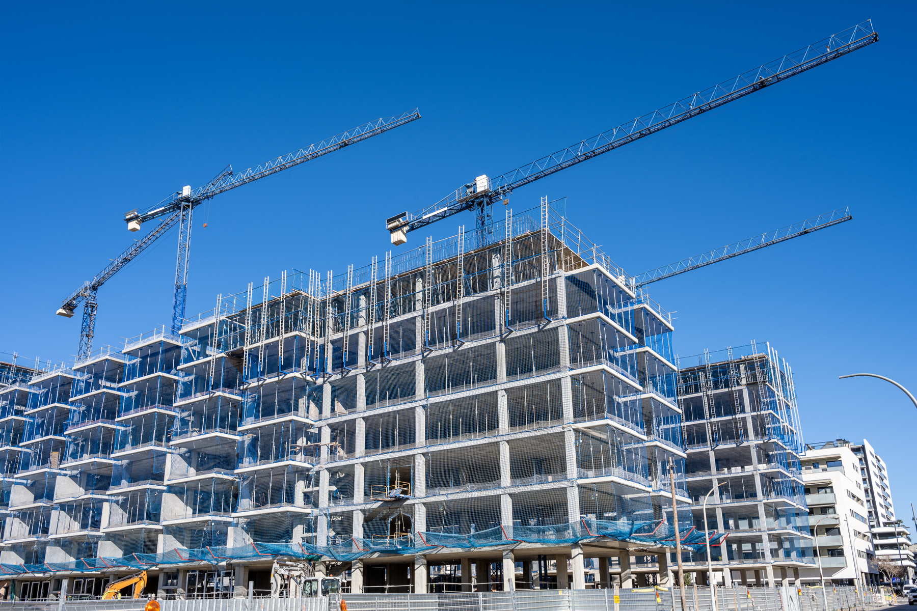 Construction site with cranes for residential buildings seen in Barcelona, Spain